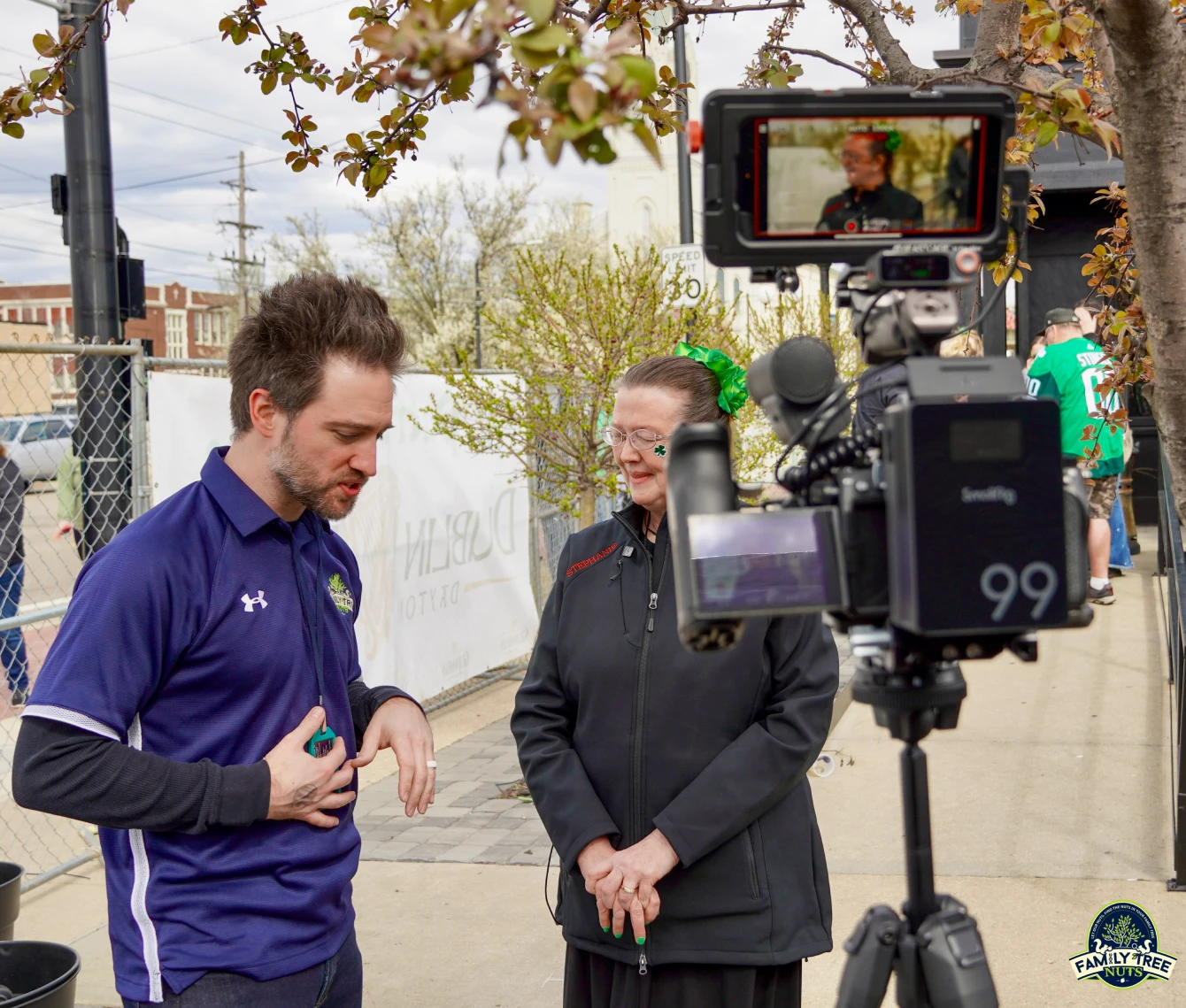 A man and woman are talking to the camera.