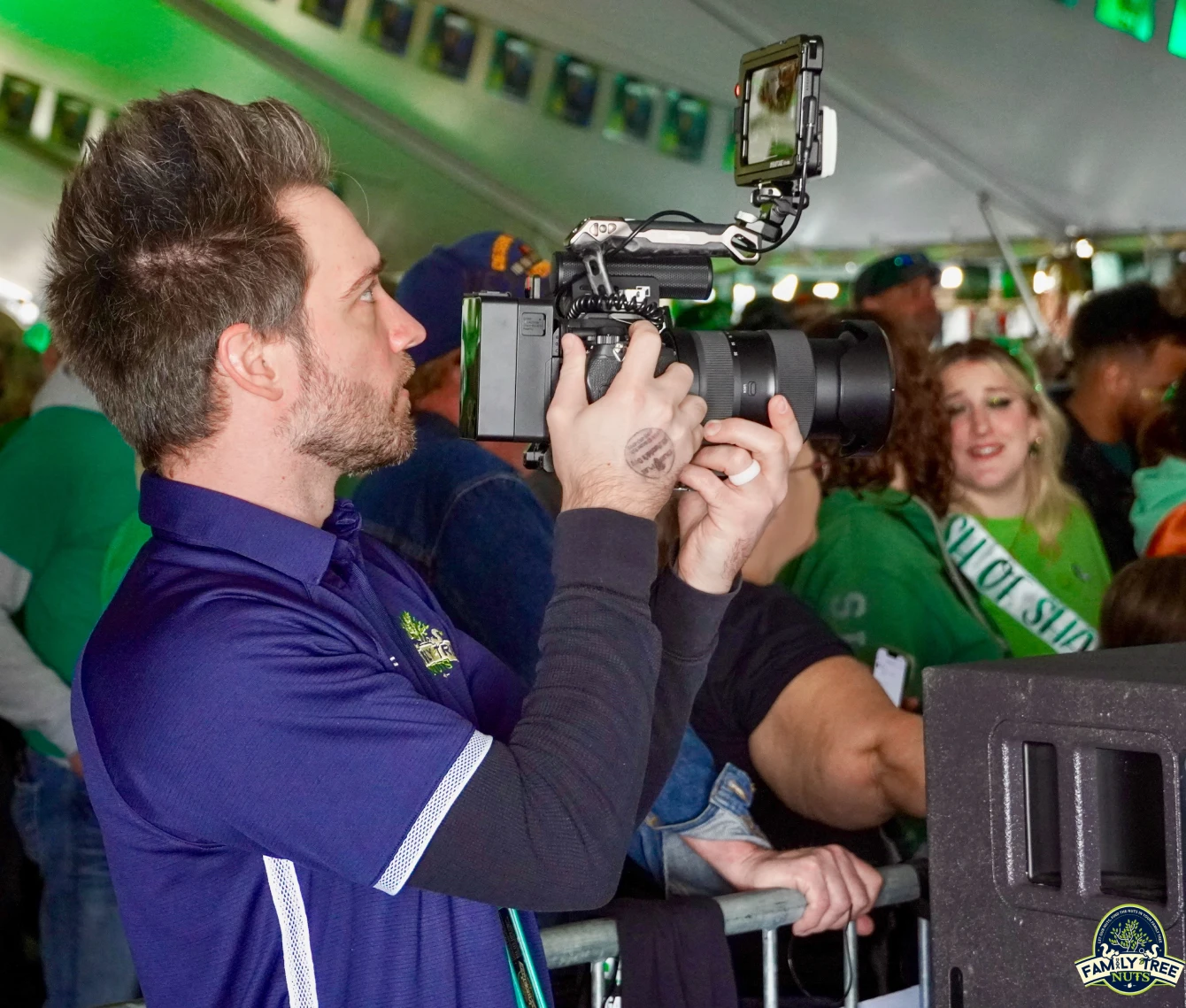 A man holding a camera up to the side of his head.