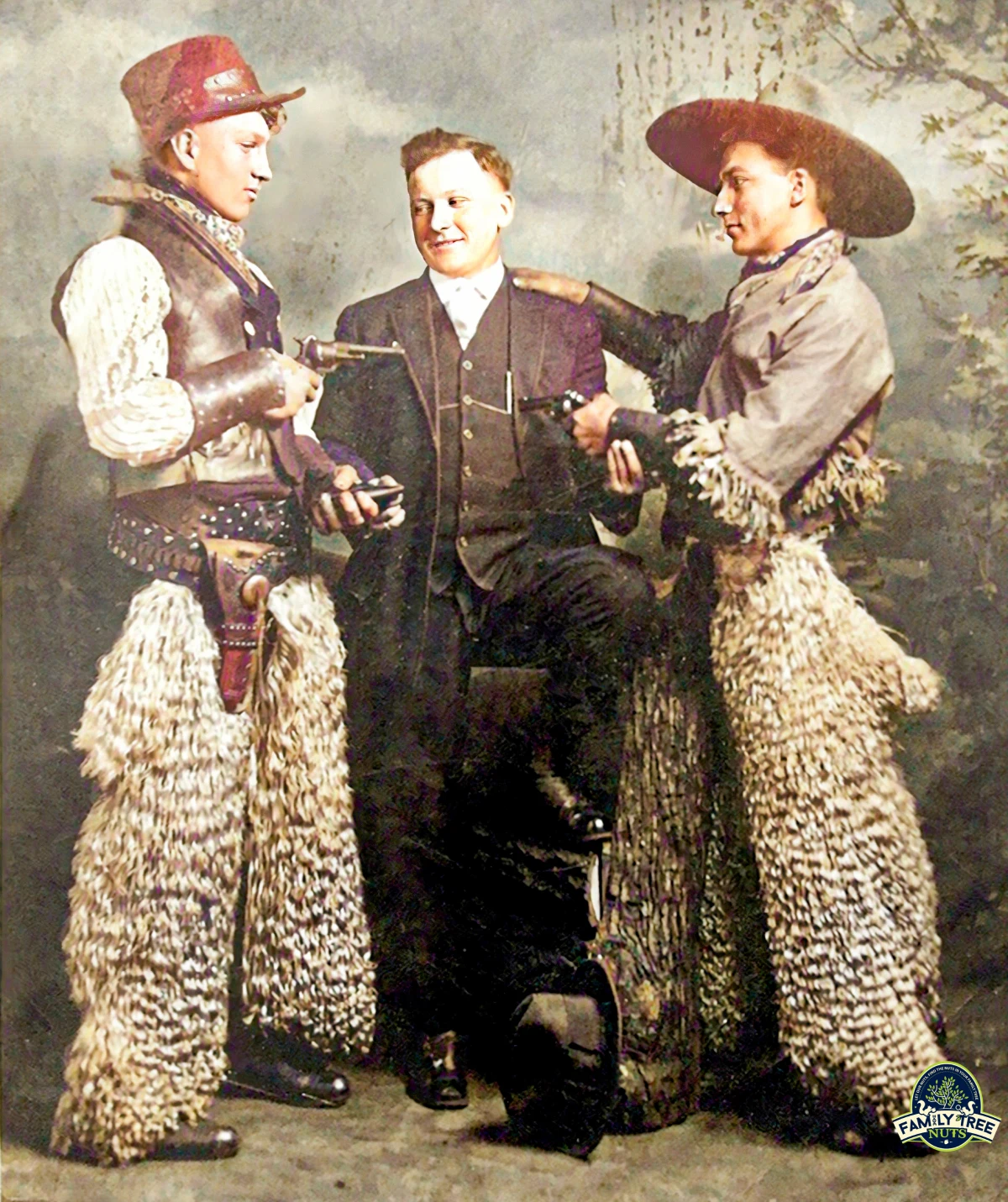 A man in a suit and two men in cowboy hats.