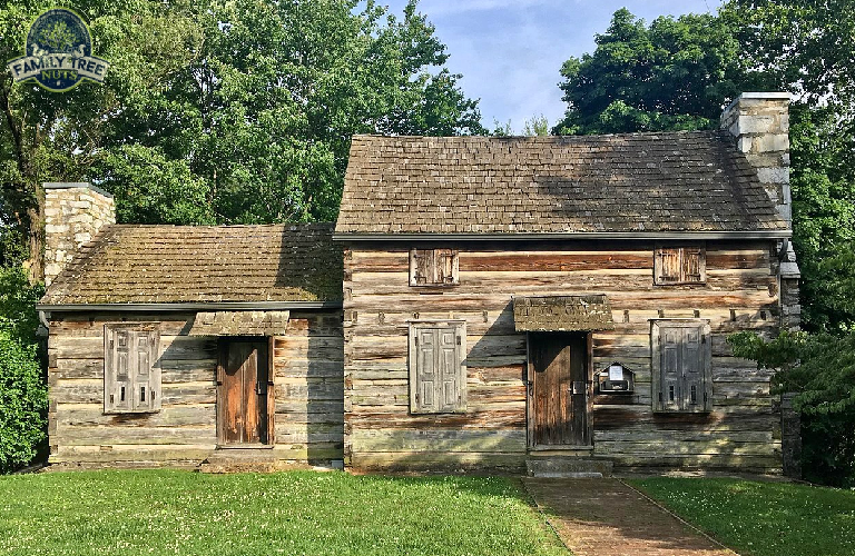 A log cabin with two doors and a porch.